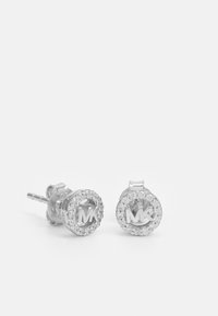 Silver stud earrings featuring a circular design, embellished with stones around a central "MK" logo. Smooth texture and polished finish.