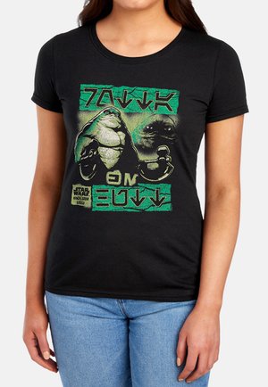 Woman wearing black Star Wars t-shirt featuring character Jabba the Hutt with green and beige graphic and text in alien script.