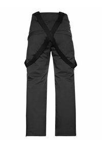Pantaloni impermeabili neri con vita alta, dotati di cinghie incrociate sul retro, aperture con zip all'orlo e numerose tasche.