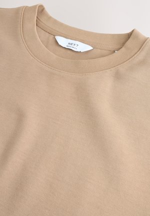 Beige sweatshirt med rund hals, lavet af blødt stof. Syningerne er rene, og teksturen ser glat ud med et design i almindelig pasform.