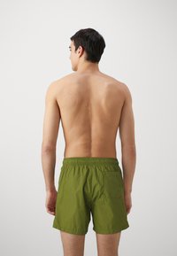 HUGO HAITI - Swimming shorts - open green