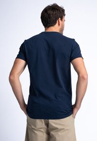 Navy blue cotton t-shirt with short sleeves, round neckline, and a regular fit. Smooth texture with no visible patterns or accents.