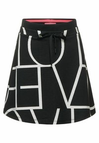 Svart kjol med vita geometriska bokstäver. Har en dragsko vid midjan och ett rosa foder. Mjuk, elastisk tyg, utställd design.