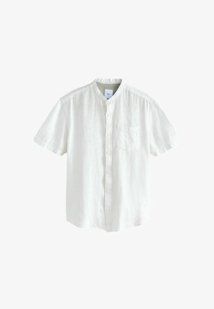 Lühikeste varrukatega valge lina särgiga, millel on mandariinikaelus ja üks rinnatasku. Sile tekstuur ja nööpidega esikinnitus.