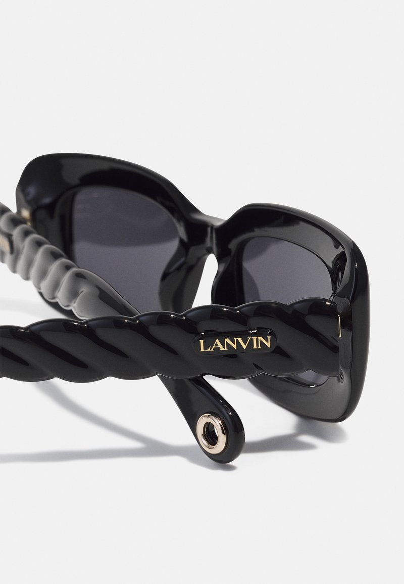 Black sunglasses with thick frames, dark lenses, and twisted black temple arms featuring a gold "LANVIN" logo detail.
