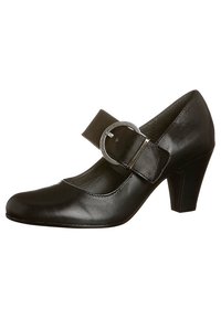 Černá kožená obuv typu Mary Jane s kulatou špičkou, nízkým podpatkem a širokým pásem s kruhovou stříbrnou sponou. Hladký povrch a minimalistický design.