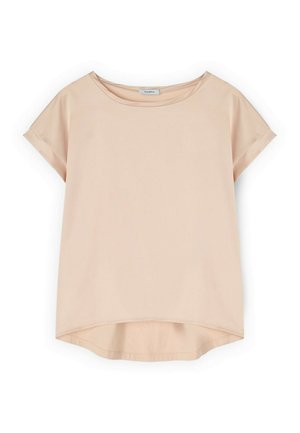 Beżowa damska koszulka z krótkim rękawem, z podwiniętymi mankietami i zaokrąglonym dołem, nieco dłuższa z tyłu.