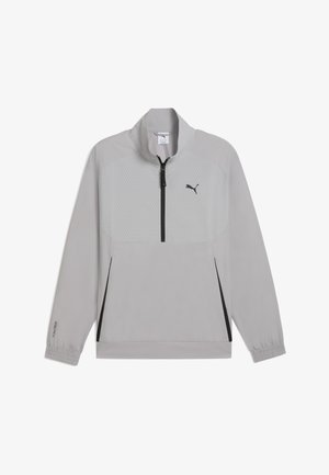 Lys grå pulloverjakke med kvart lynlås, der har et mønstret forpanel, sort lynlås og elastiske manchetter. Letvægts, sporty design.