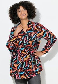 Camicia a maniche lunghe con sfondo nero, caratterizzata da vivaci motivi di foglie in rosso, blu e arancione. Vestibilità ampia con scollatura a V.