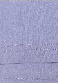 Lilac cotton fabric showing textured ribbing, with visible stitching at the joining edge, highlighting a soft and smooth finish.