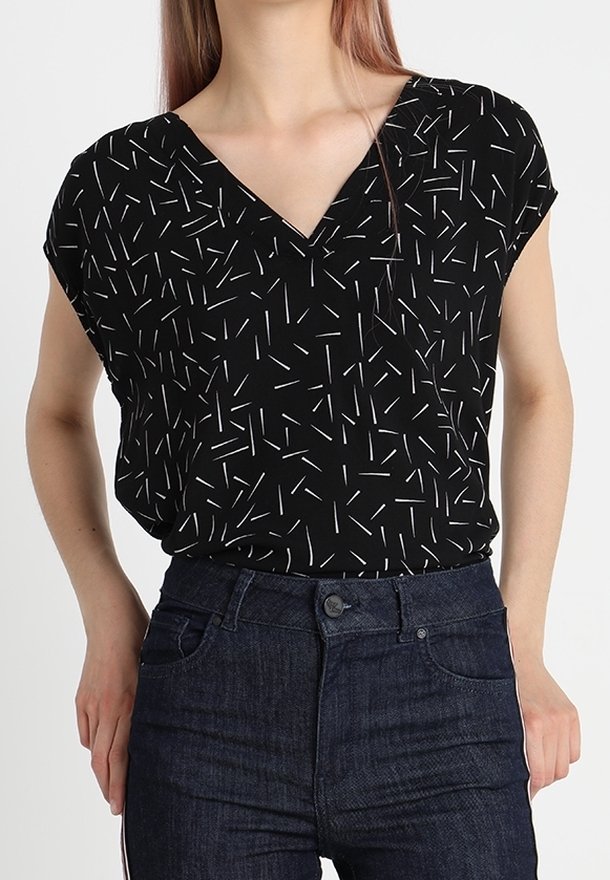 Black short-sleeve top with a V-neck, featuring a scattered white line pattern. Paired with dark blue jeans. Smooth fabric texture.