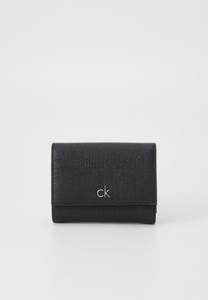 Musta nahkainen lompakko, jossa on luonnollinen pinta, etupuolella hopeinen "ck"-logo ja taitettavan muotoilun.