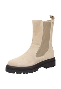 Beige Wildleder Stiefelette mit elastischen Seitenpaneelen und einer robusten schwarzen Sohle. Verfügt über eine Zuglasche für einfaches An- und Ausziehen sowie eine glatte Oberfläche.