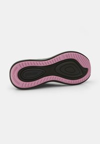 Black and pink athletic shoe sole with a textured design, featuring a pink traction pattern and "POWER" branding on a black background.