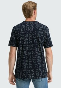 Dark navy T-shirt with a geometric pattern featuring light blue accents, short sleeves, and a relaxed fit.  Cotton blend material.