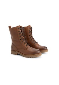 Une paire de bottes en cuir marron à lacets avec des zips sur les côtés et des semelles en caoutchouc, présentée sur fond blanc.