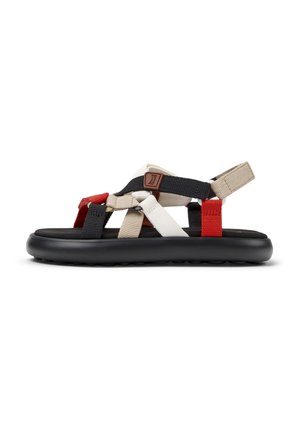Black sandal with layered webbing straps in red, white, and beige. Features a cushioned black sole and adjustable heel strap.