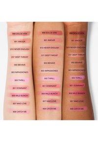 Trois bras avec des teints de peau différents présentent des échantillons de dix couleurs pour lèvres ou joues, chacun étiqueté avec son nom et son numéro pour comparaison des teintes.
