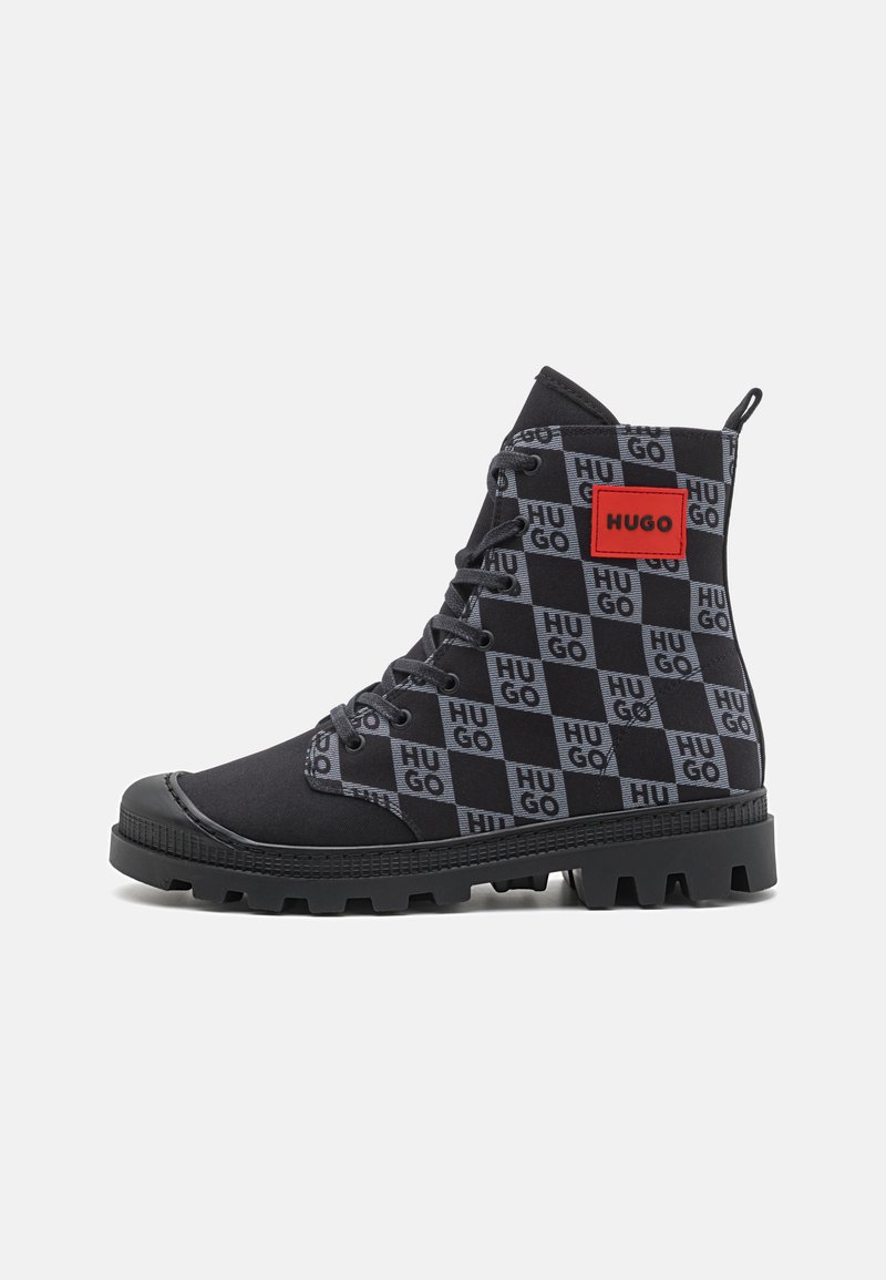 Black boots with a checkerboard pattern featuring the word "HUGO" in grey and red accents, textured fabric, rubber sole, and lace-up design.