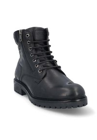 Bottine en cuir noir avec lacets et fermeture éclair sur le côté, présentant un extérieur texturé, un bout renforcé et une semelle robuste pour une meilleure adhérence.