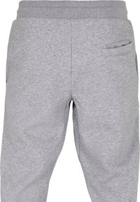 Grijze sweatpants van een zachte katoenmix, met een geribde tailleband en een klein zijvakje. Minimalistisch ontwerp met een gladde textuur.