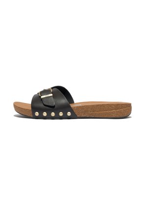 Black slide sandal featuring a wide strap with a buckle, cork midsole, textured footbed, and decorative round studs along the edge.
