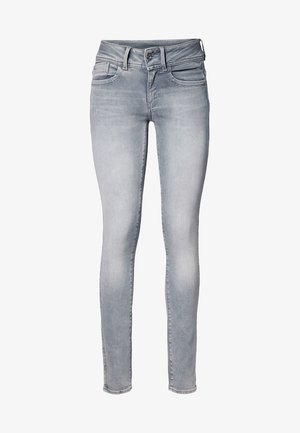 Light gray skinny jeans with front and back pockets, belt loops, button closure, and faded detailing on thighs and knees.