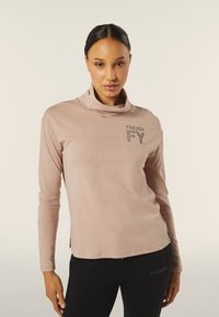 Maglietta lunga rosa chiaro a maniche lunghe con collo a imbuto, caratterizzata dalla parola ricamata "FREDDY" decorata con strass sul petto.