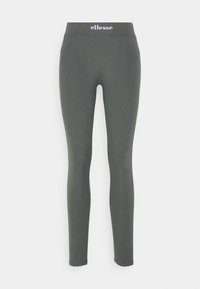 Leggings verts avec une taille haute, fabriqués en matériau extensible. Présente un petit logo violet clair en haut. Texture lisse.