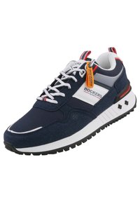 Navy sneaker with a fabric upper, white accents, and a textured rubber sole. Features a lace-up design and an orange tag. Black star accents on the side.