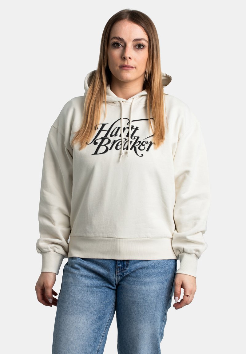 Crème-kleurige hoodie van zachte stof, met een zwart grafisch tekst "Harry Breaker" op de voorkant. Inclusief een capuchon met koord.