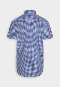 Camicia a maniche corte in una fantasia a scacchi blu e bianca, con colletto button-down, orlo dritto e tessuto di cotone testurizzato.