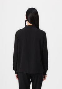 Black long-sleeve blouse with a smooth texture, featuring a collar and gathered sleeves, shown from the back against a plain background.