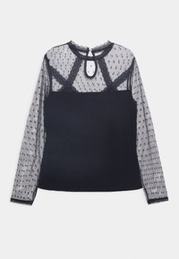 Svart topp med långa genomskinliga meshärmar som har prickar och spetsdetaljer, nyckelhål på baksidan, figurnära bodice och rund krage.