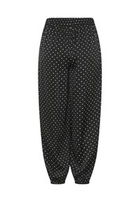 Pantalon noir ample à pois blancs, taille élastique et poignets élastiques aux chevilles.