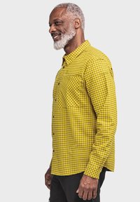 Gelb kariertes Hemd mit Button-Down-Kragen, ausgestattet mit einer Brusttasche und einem kontrastierenden Karomuster. Lange Ärmel, lässige Passform.