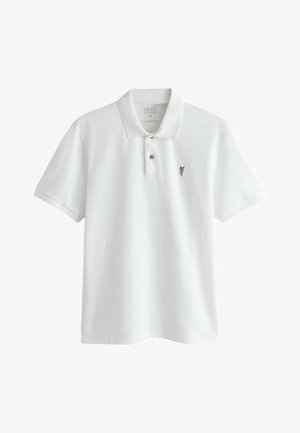 Biała koszulka polo z krótkim rękawem, kołnierzykiem, dwoma guzikami oraz małym, haftowanym wielokolorowym kwiatem na lewej piersi.