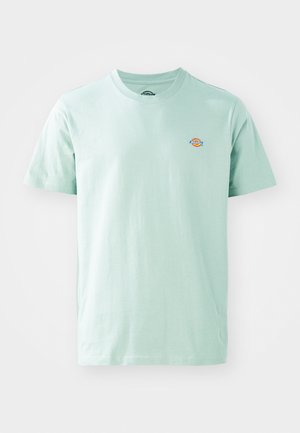 Light green cotton t-shirt with a round neckline and short sleeves. Features a small, colorful logo on the chest.