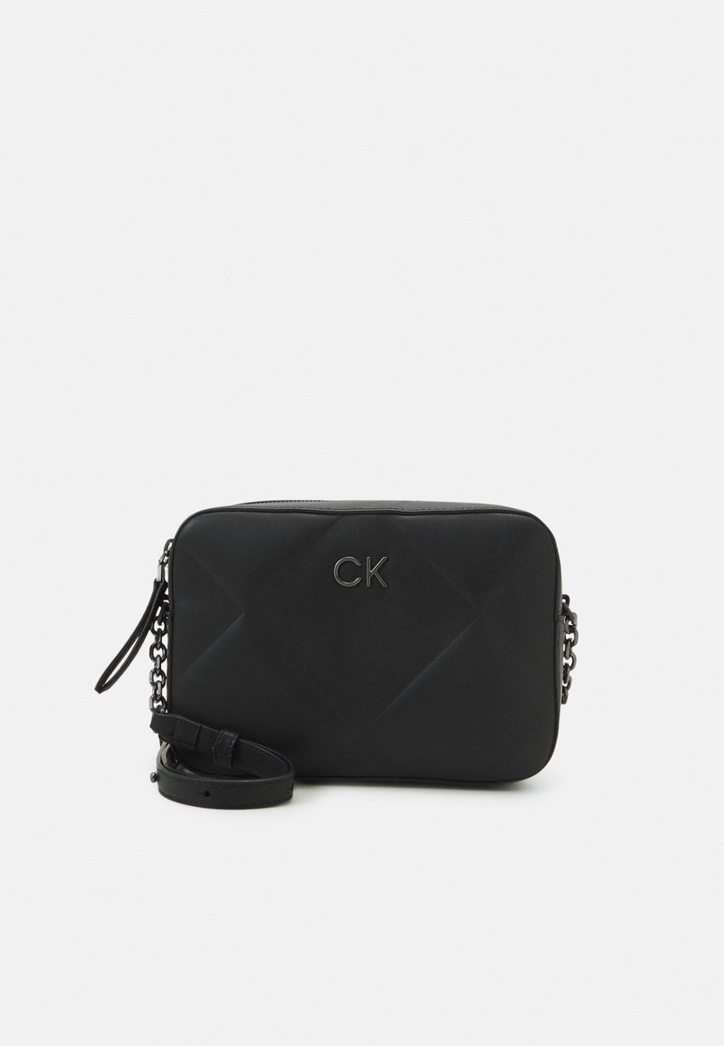 Black quilted crossbody bag with a smooth texture, chain hardware, and a debossed logo. Features a removable strap and rectangular shape.