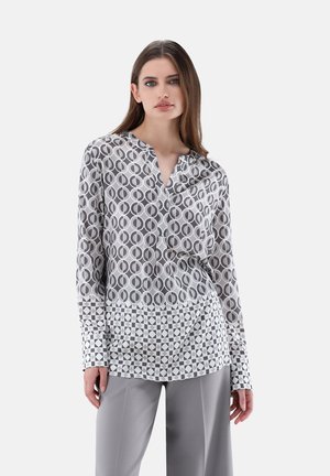 Langarmbluse aus leichtem Stoff mit einem kreisförmigen und geometrischen Muster in Grautönen und Weiß sowie einem Kragen.