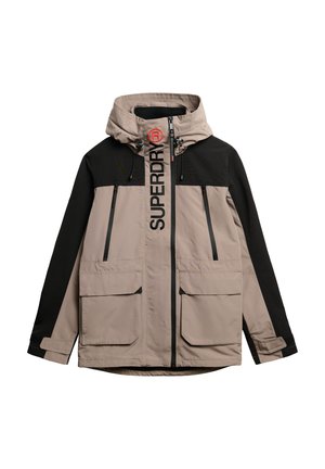 Lichtgewicht gewatteerd jack in beige en zwart, met ritszakken, een opvallend logo op de borst en verstelbare trekkoorden aan de kap.