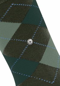 Chaussette à motifs présentant un design en diamant dans les nuances de vert foncé, vert clair et bleu. Fabriquée en tissu avec une texture visible et un détail de bouton avec logo.