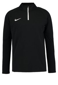 Haut sportif noir à manches longues avec un col à demi-fermeture éclair, fabriqué dans un matériau lisse et léger. Doté d'un logo Nike blanc sur la poitrine.