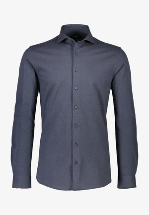 Tummansininen pitkähihainen nappipaita, jossa on klassinen kaulus, hienovarainen tekstuuri ja mustat napit. Muodikas istuvuus pyöristettyine helmoineen.