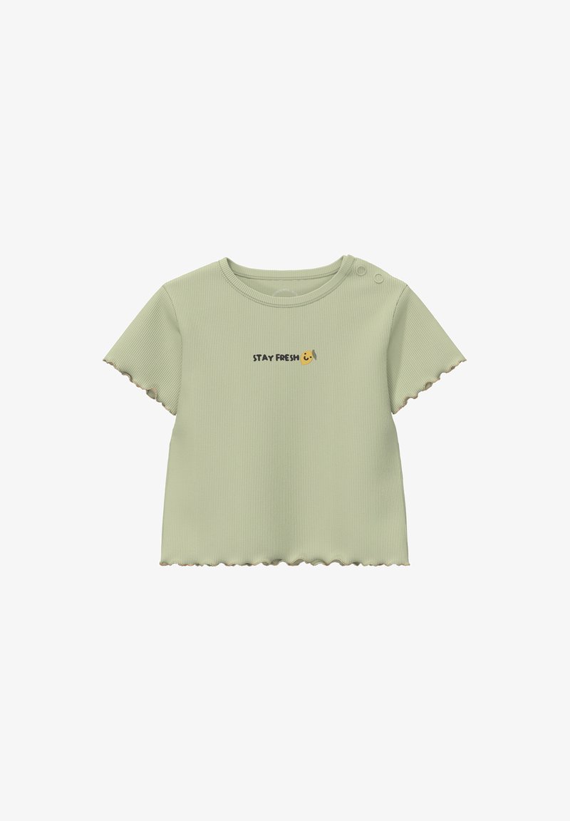 Chemise à manches courtes côtelée vert clair avec des bords festonnés et deux boutons aux épaules, arborant le texte "STAY FRESH" et une icône de visage souriant.