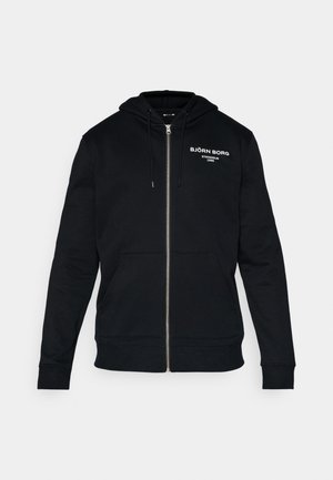 Svart zip-up hettegenser laget av blandingsbomull, med snor i hetten, kengurulommer og hvit logo-tekst på brystet.
