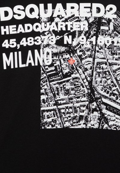 Black T-shirt featuring white text and a map graphic of Milan, with a red maple leaf accent. Text includes brand name and coordinates.