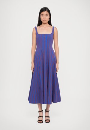 Blue and red striped maxi dress with a square neckline, fitted bodice, flared skirt, and thin shoulder straps. Smooth fabric texture.