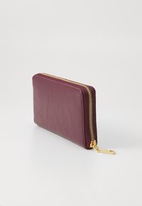 Burgundy leather wallet with a smooth texture, gold zipper closure, and a squared shape. The zipper pull features a square hardware detail.