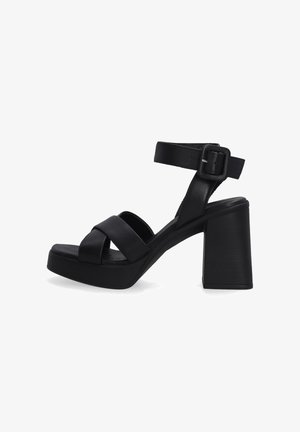 Black leather platform sandals with a thick block heel, crisscross strap design, and adjustable ankle buckle for secure fit.